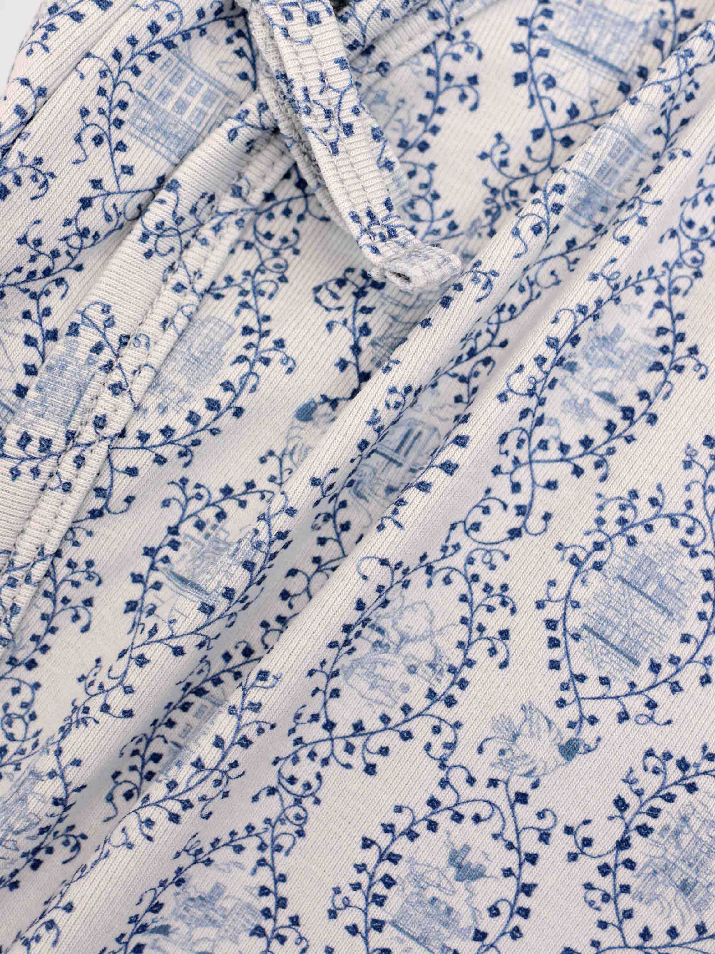 Blue Charm Blanket for boys swaddle featuring a dark blue vine pattern on white fabric