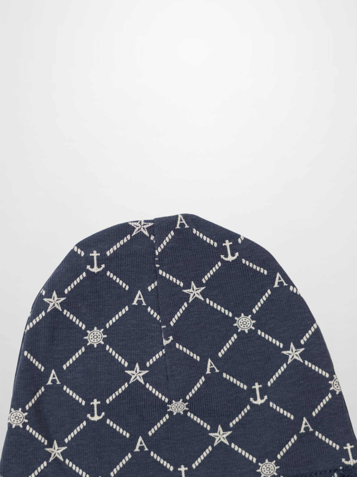 Navy Crossover Beanie with white rope diamond pattern, accented by anchors, stars, ship wheels and A.
