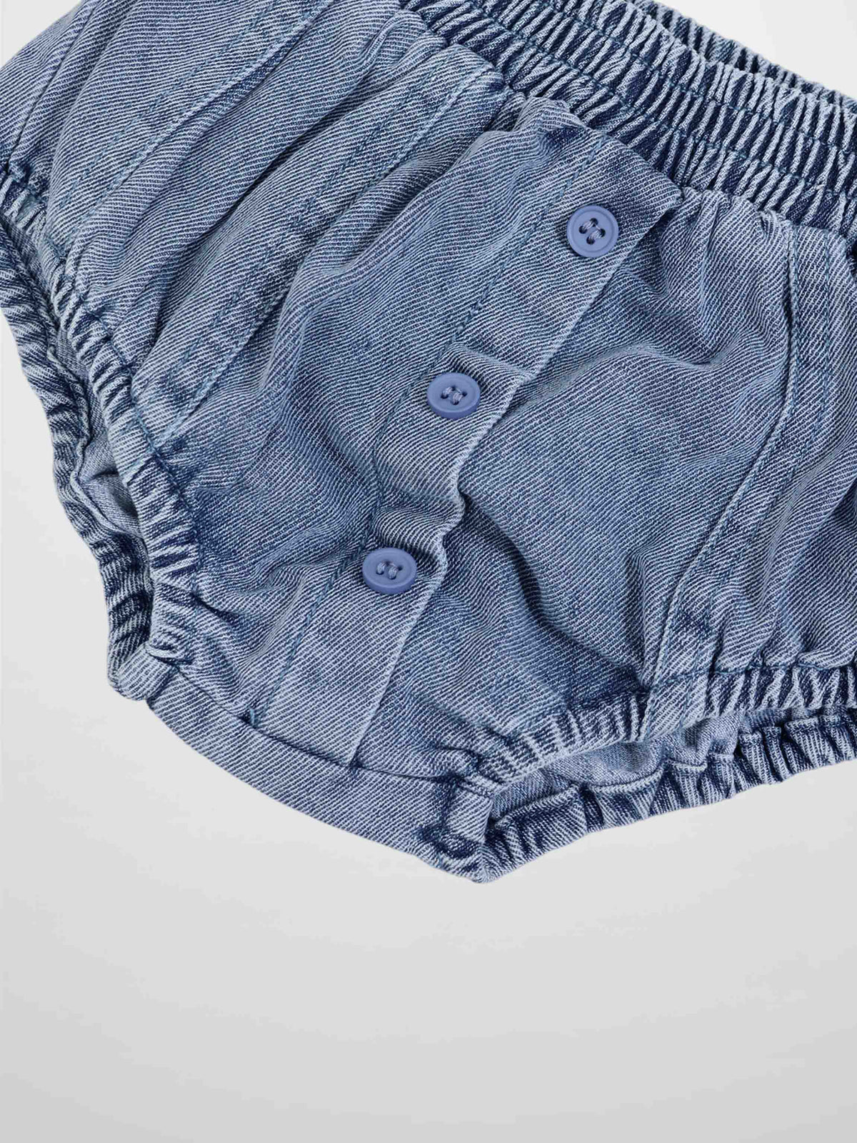 Paneled bloomers in blue denim with elastic waist and leg openings, front button placket.