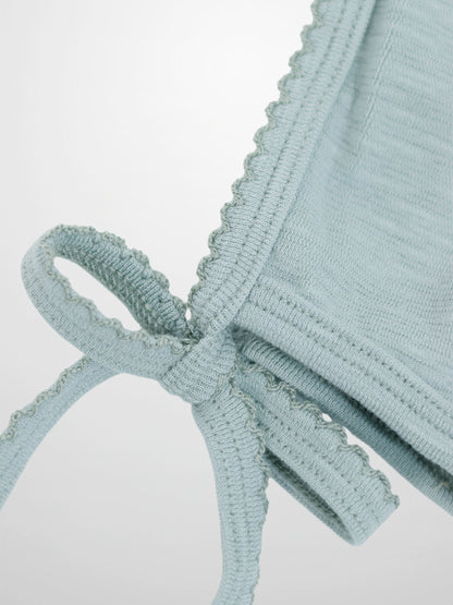 Blue scalloped bonnet for boys by Adee, soft light-blue knit with tied strings.
