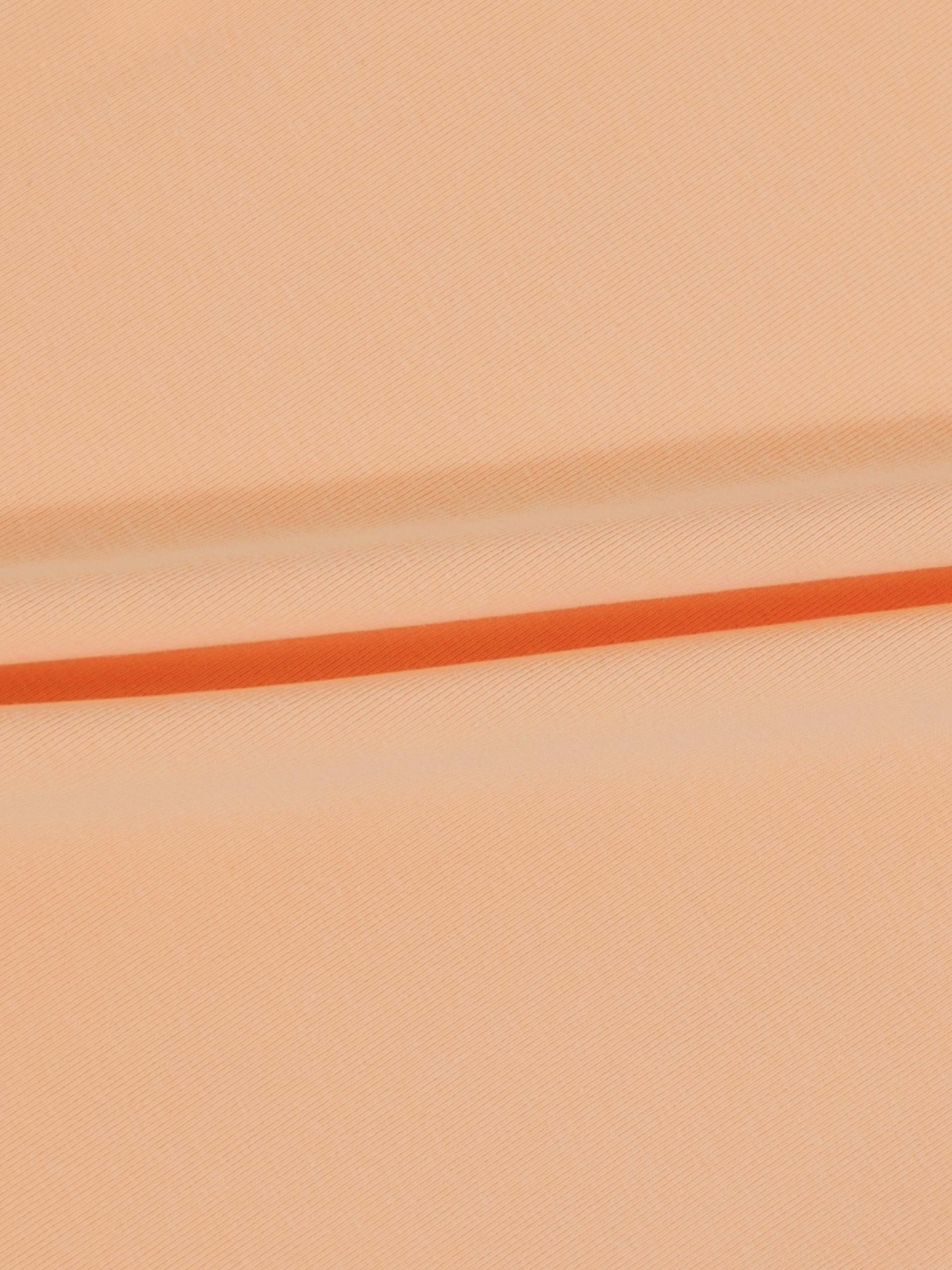 Peach 3/4 puff sleeve T-shirt fabric close-up with orange stripe.