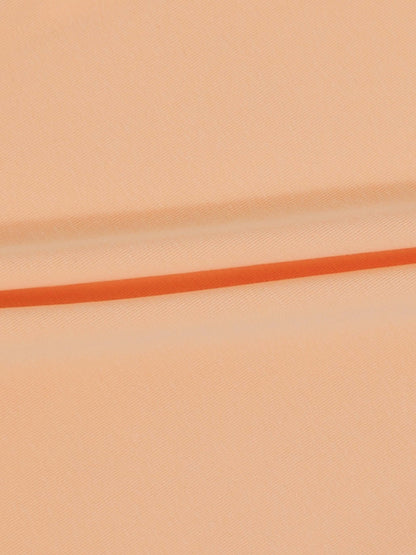 Peach fabric close-up with an orange seam line, for a 6-panel skirt design.