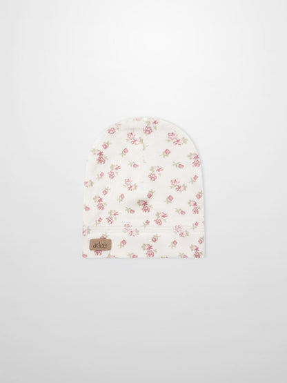 Tiny Blossom Hat by Adee, cream beanie with pink floral print and leather patch