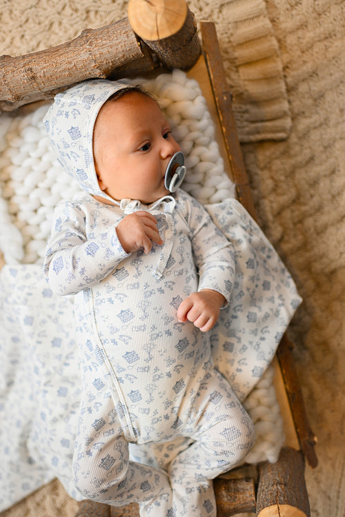 Little Storybook Stretchy - Blue baby footie with carousels, teddy bears, balloons, rocking horses.