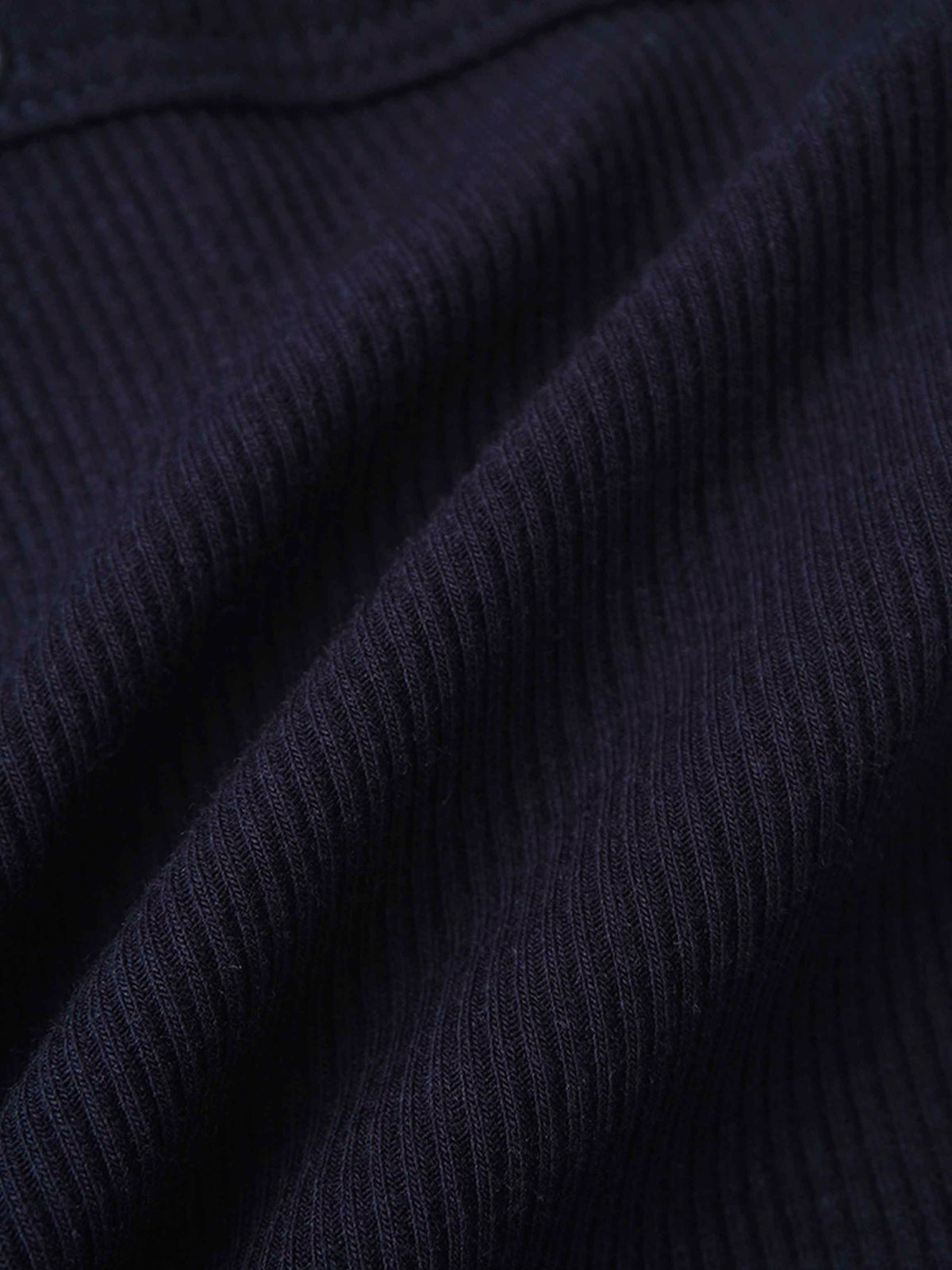 Close-up of navy ribbed knit fabric for a baby boy footie with a mock neck.