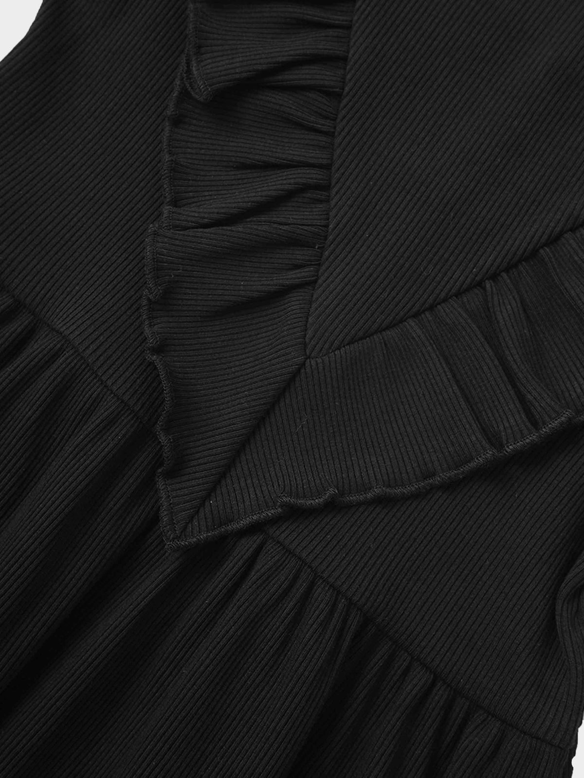 Close-up of black ribbed fabric with layered ruffles from the Ruffle V Robe for girls.