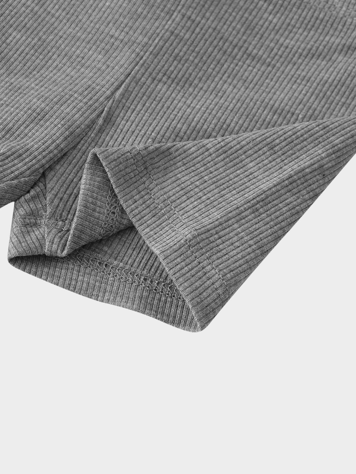 Grey thin-ribbed fabric close-up from baby and toddler biker shorts, with folded hem.