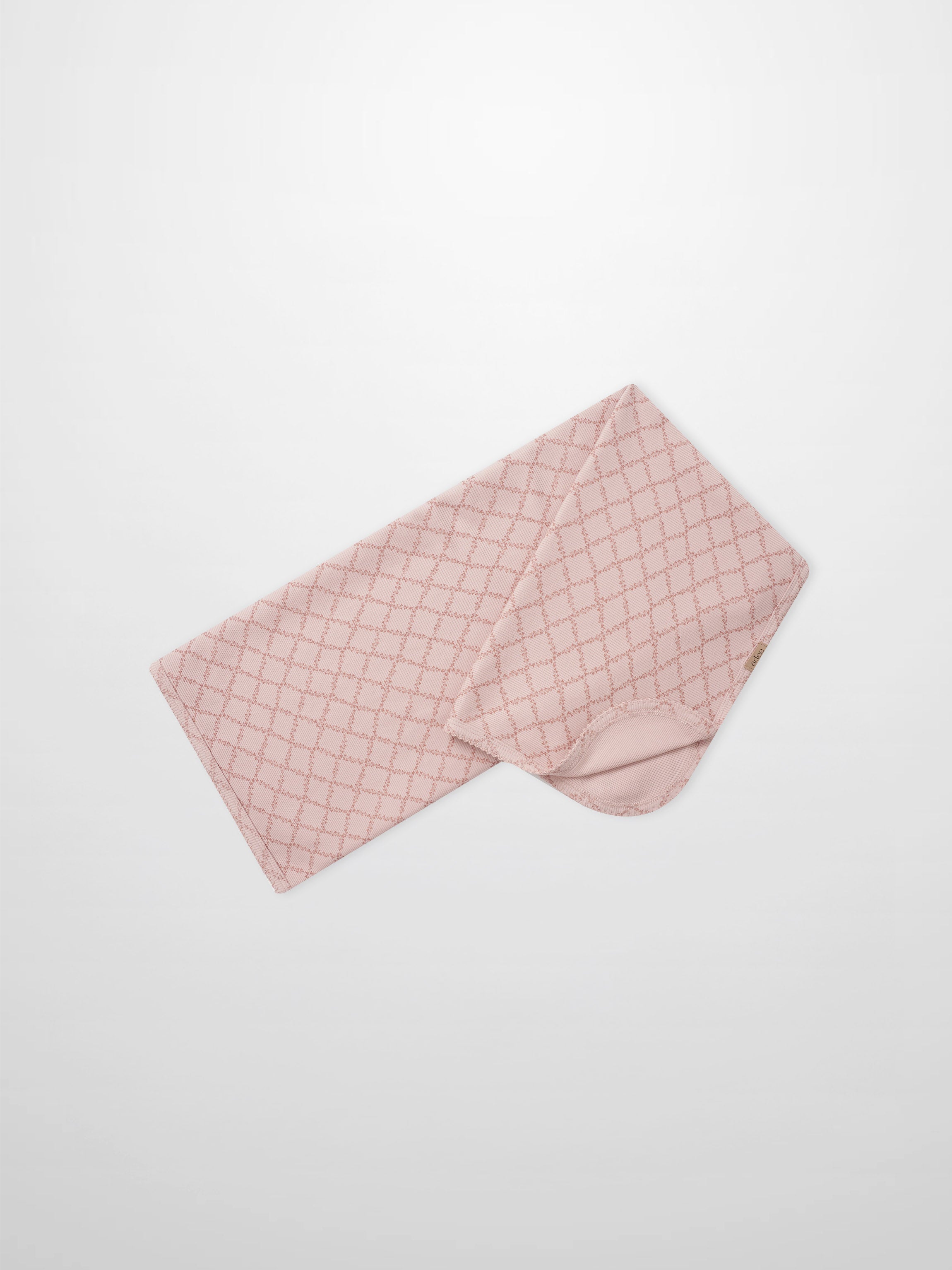 Pink Leaf Blanket swaddle by Adee, pink fabric with a lattice pattern.