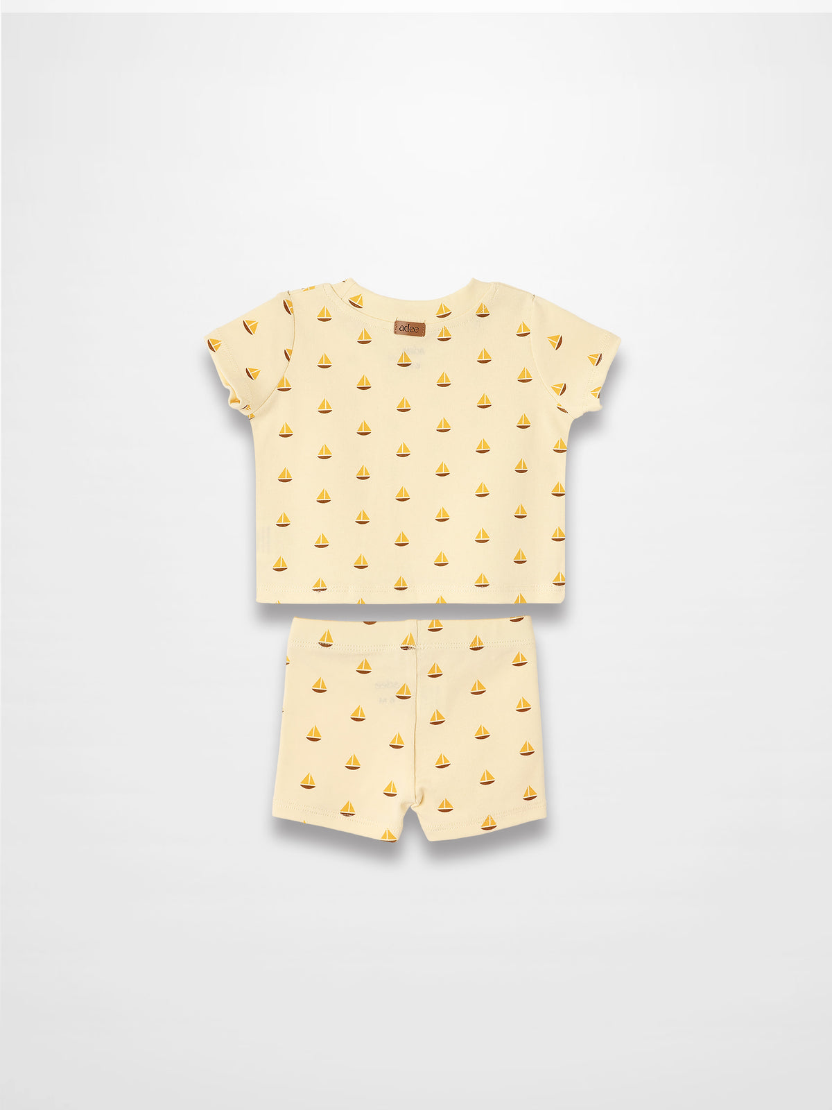 Adee Boat Print two-piece set for little boys with cream-yellow short-sleeve tee and matching shorts.