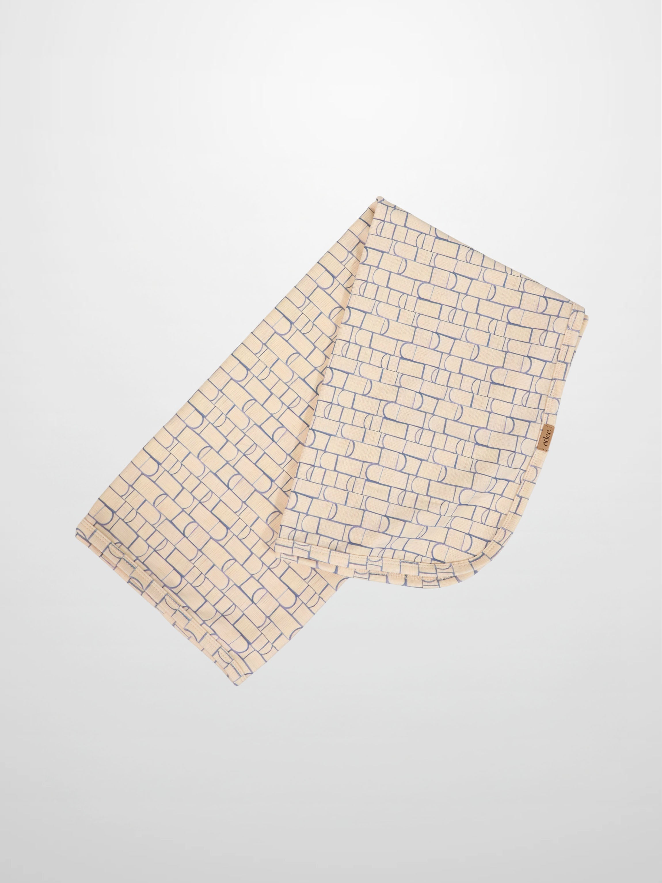 Geometric blanket by Adee; two boys swaddle blankets with light blue rounded-rectangle pattern