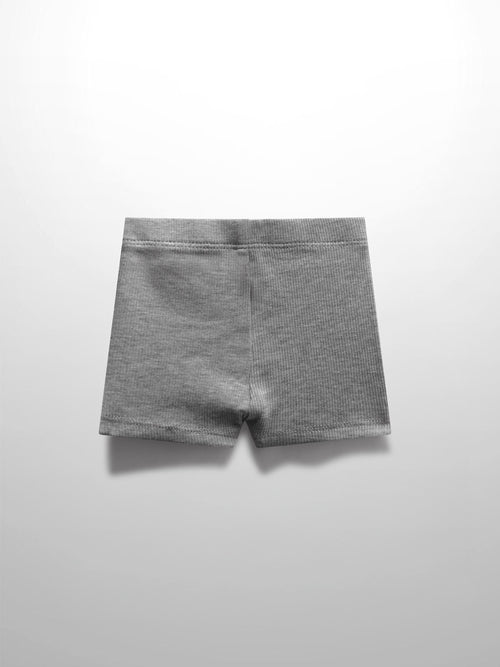 Pair of light grey thin-ribbed biker shorts with elastic waistband for babies and toddlers.
