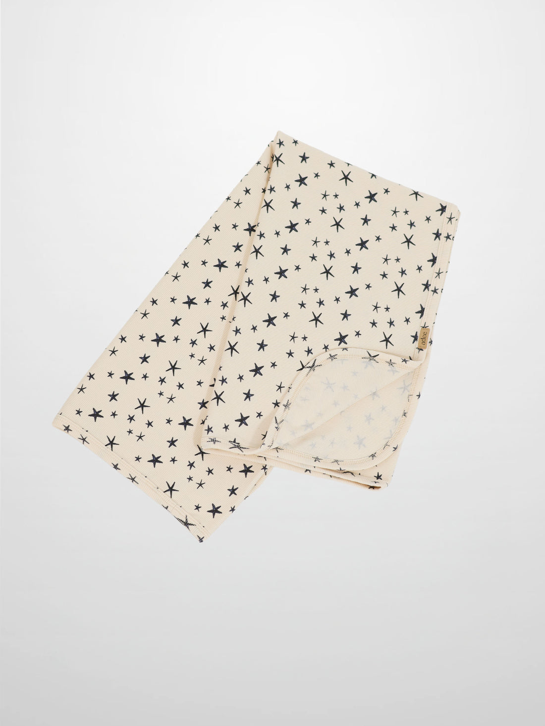 Star Blanket swaddle blanket for boys by Adee; beige with navy star pattern.