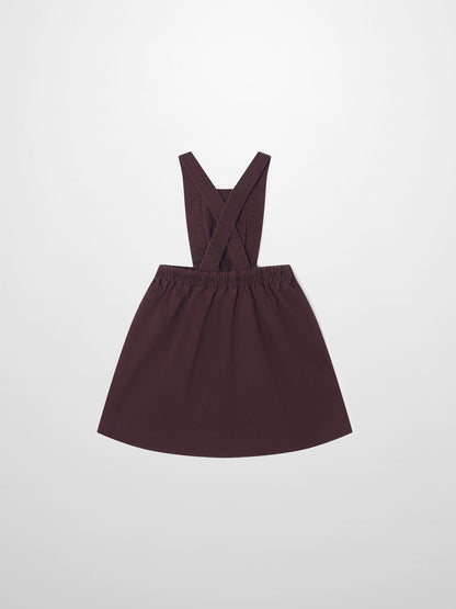 Denim jumper dress for girls in burgundy by Adee with cross-back straps