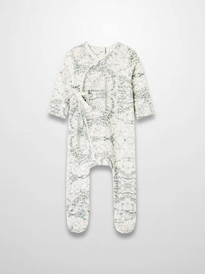 Map Stretchy baby boy footie jumpsuit with off-white background, sage map print, compass markers, and crossover tie.
