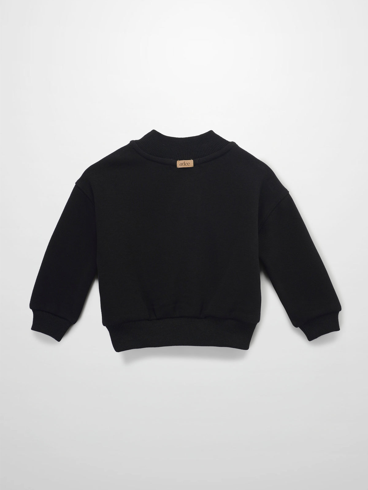 Black crewneck sweatshirt back view with ribbed cuffs and hem, beige neck label.