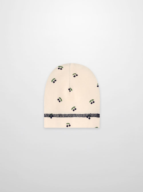 Blue Cherry Hat for boys with beige background and green leafy cherry print