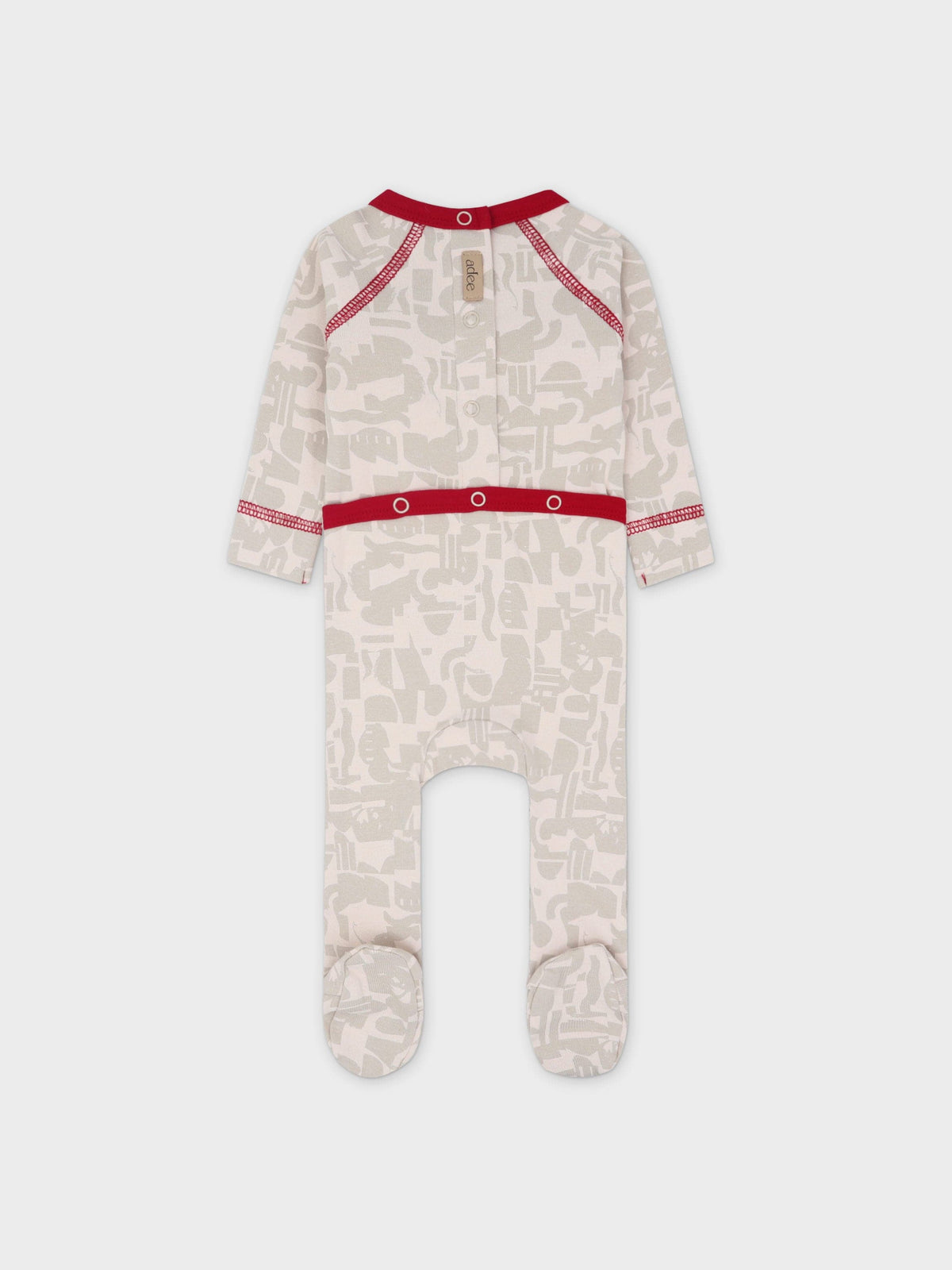 Abstract-print baby jumpsuit footie with bold red trim, beige neutrals, and a V-neck.