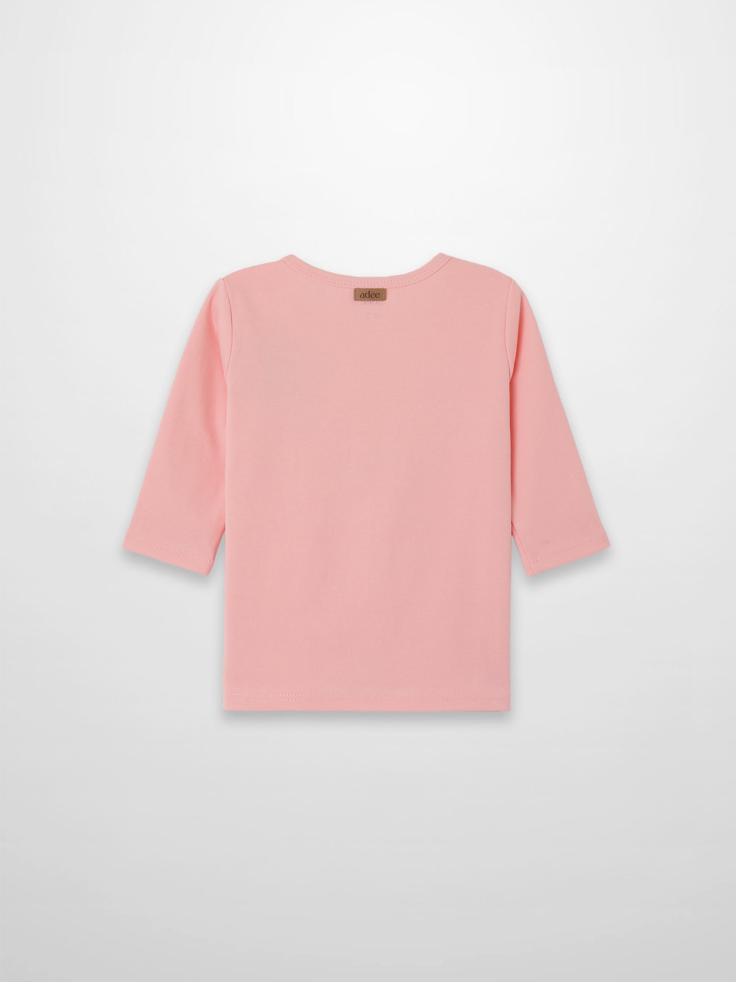 Back view of light pink 3/4 sleeve emblem T-shirt with a small brand tag at the back neckline.