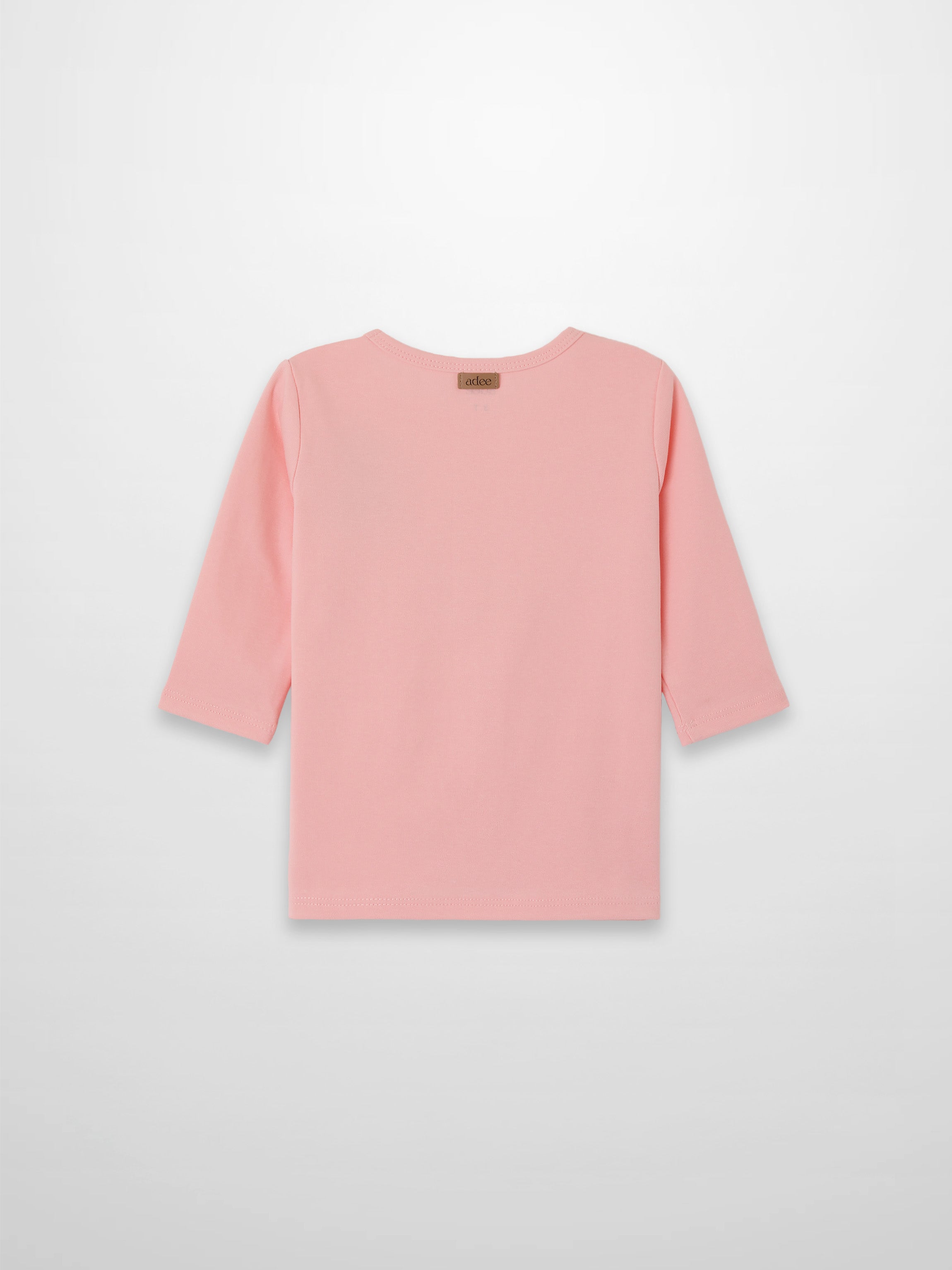 Back view of light pink 3/4 sleeve emblem T-shirt with a small brand tag at the back neckline.