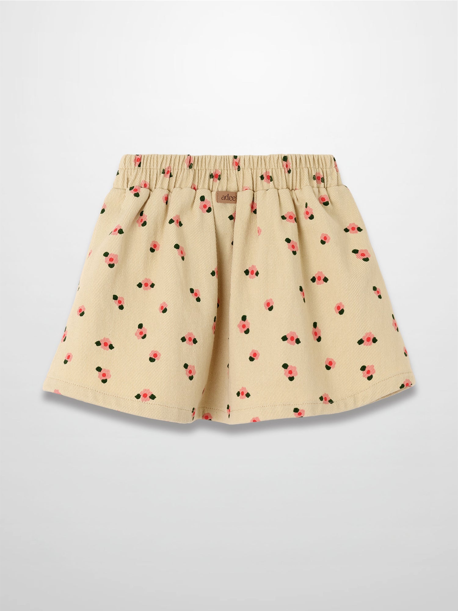 Tan floral skirt with pink blossoms and green leaves, elastic waist, A-line silhouette.