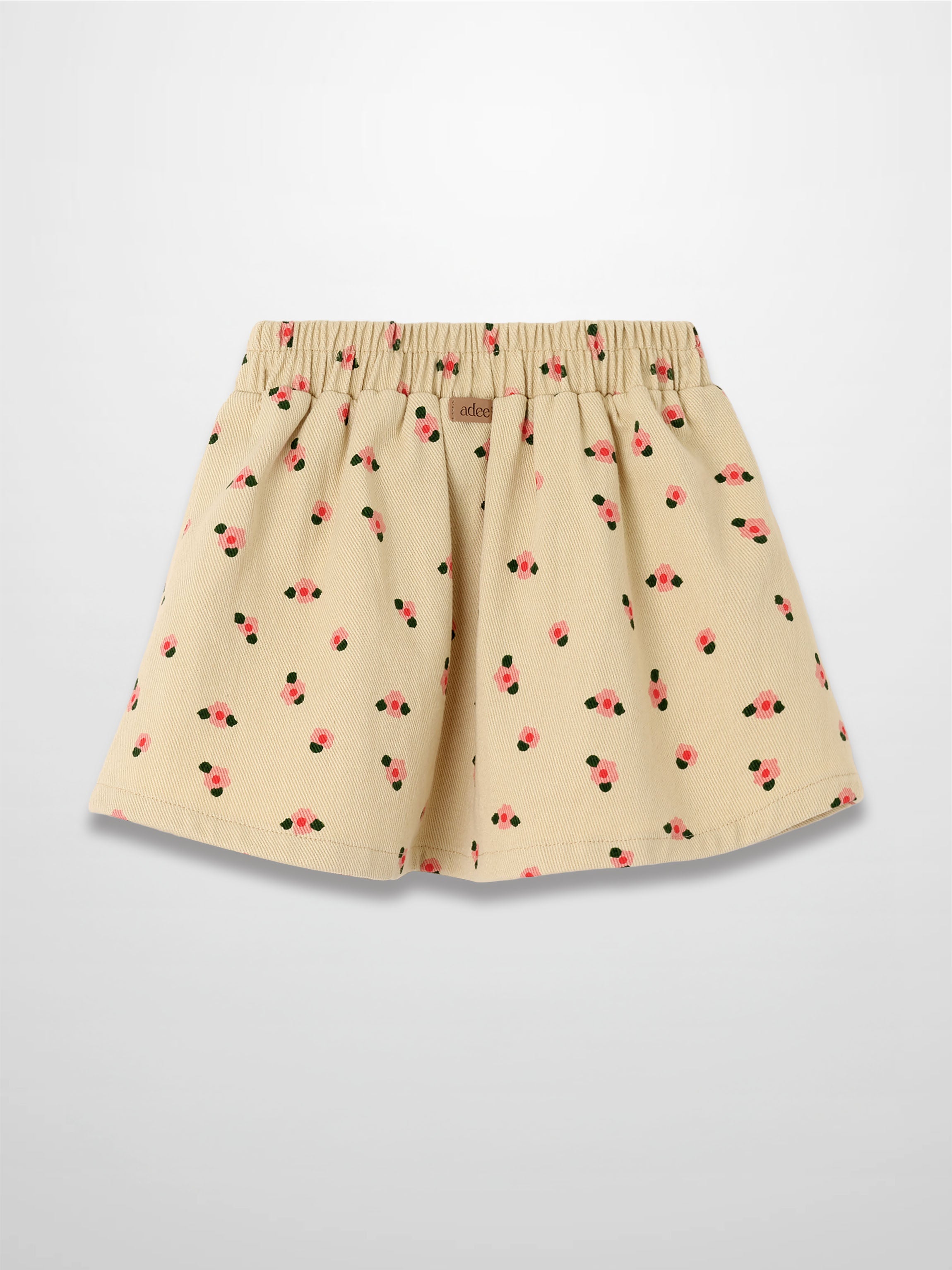 Tan floral skirt with pink blossoms and green leaves, elastic waist, A-line silhouette.