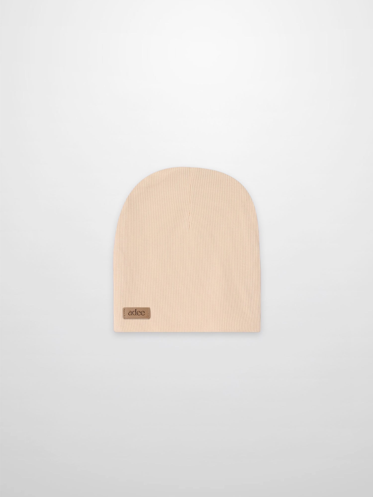 Thin ribbed tan beanie with Adee tag, unisex knit accessory.