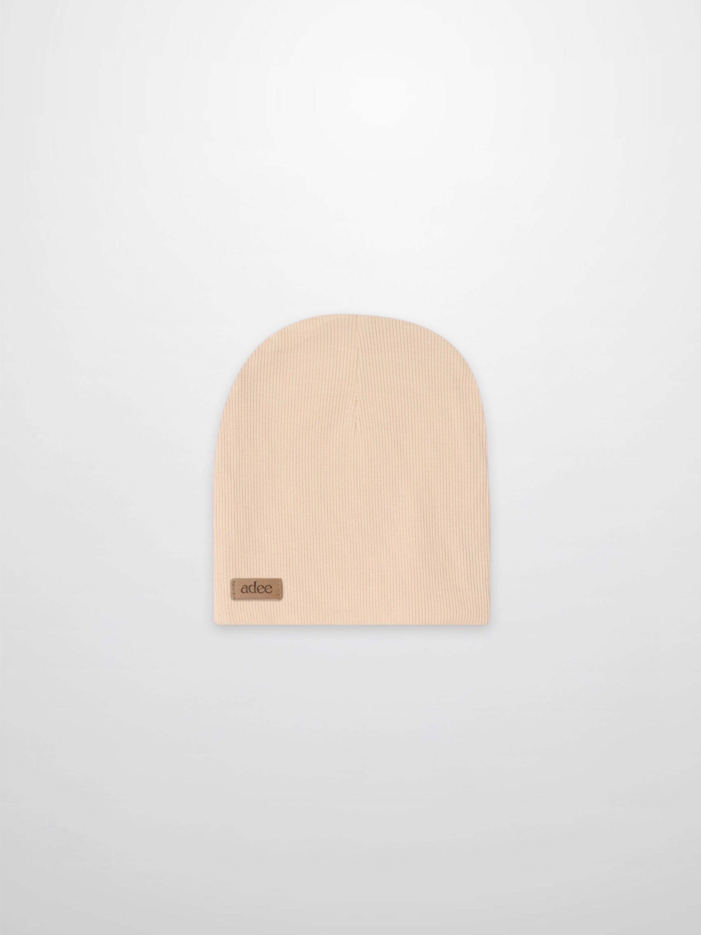 Thin ribbed tan beanie with Adee tag, unisex knit accessory.