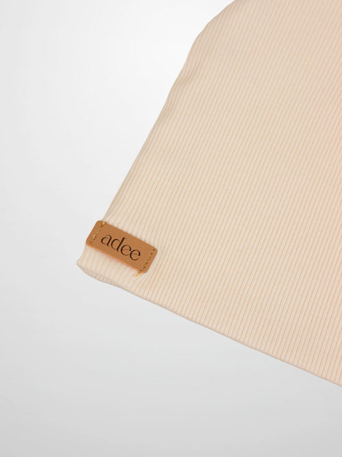 Adee unisex thin ribbed beanie in ivory with leather tag on cuff