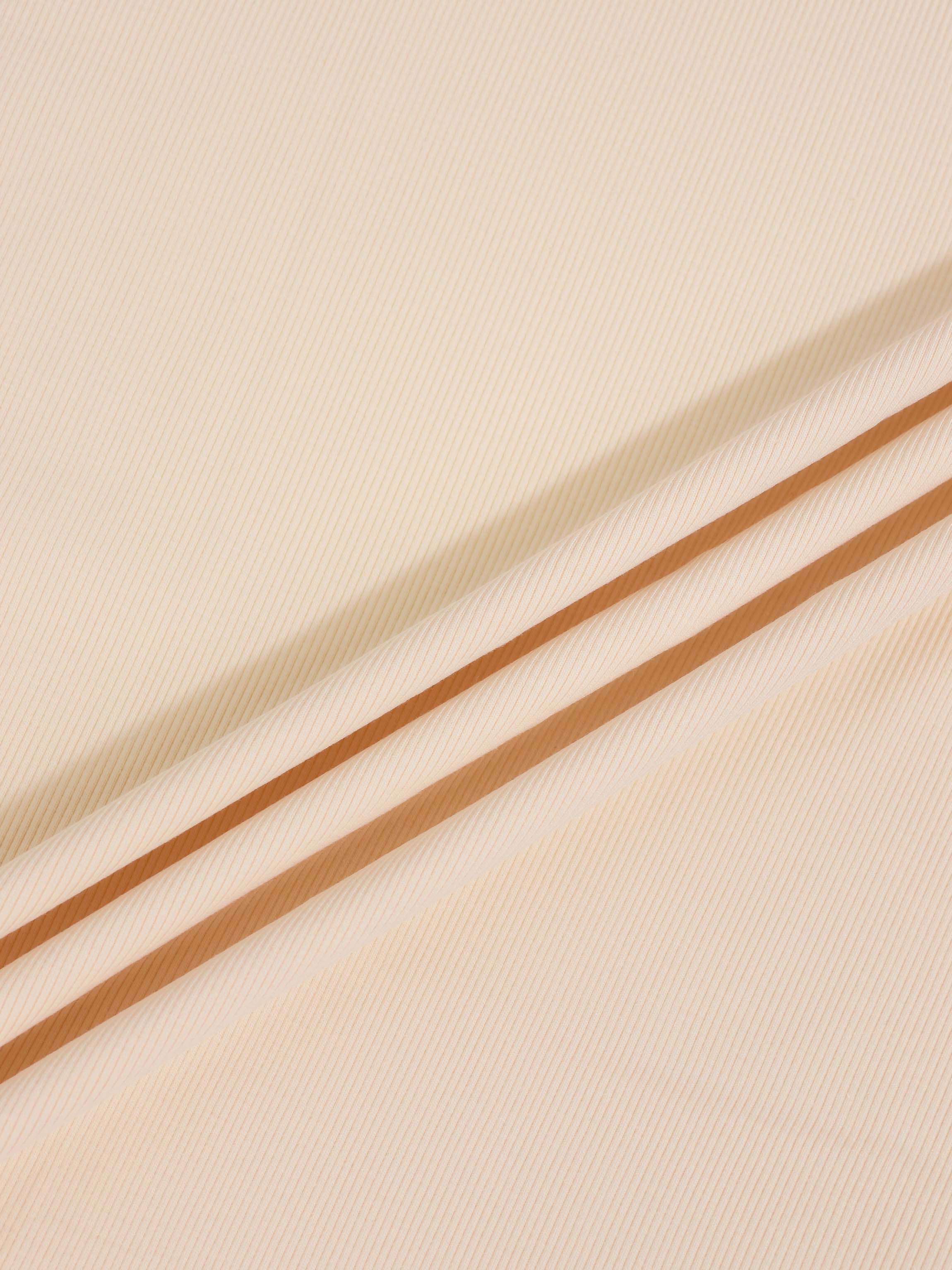 Thin ribbed tan beanie by Adee; unisex apparel accessory