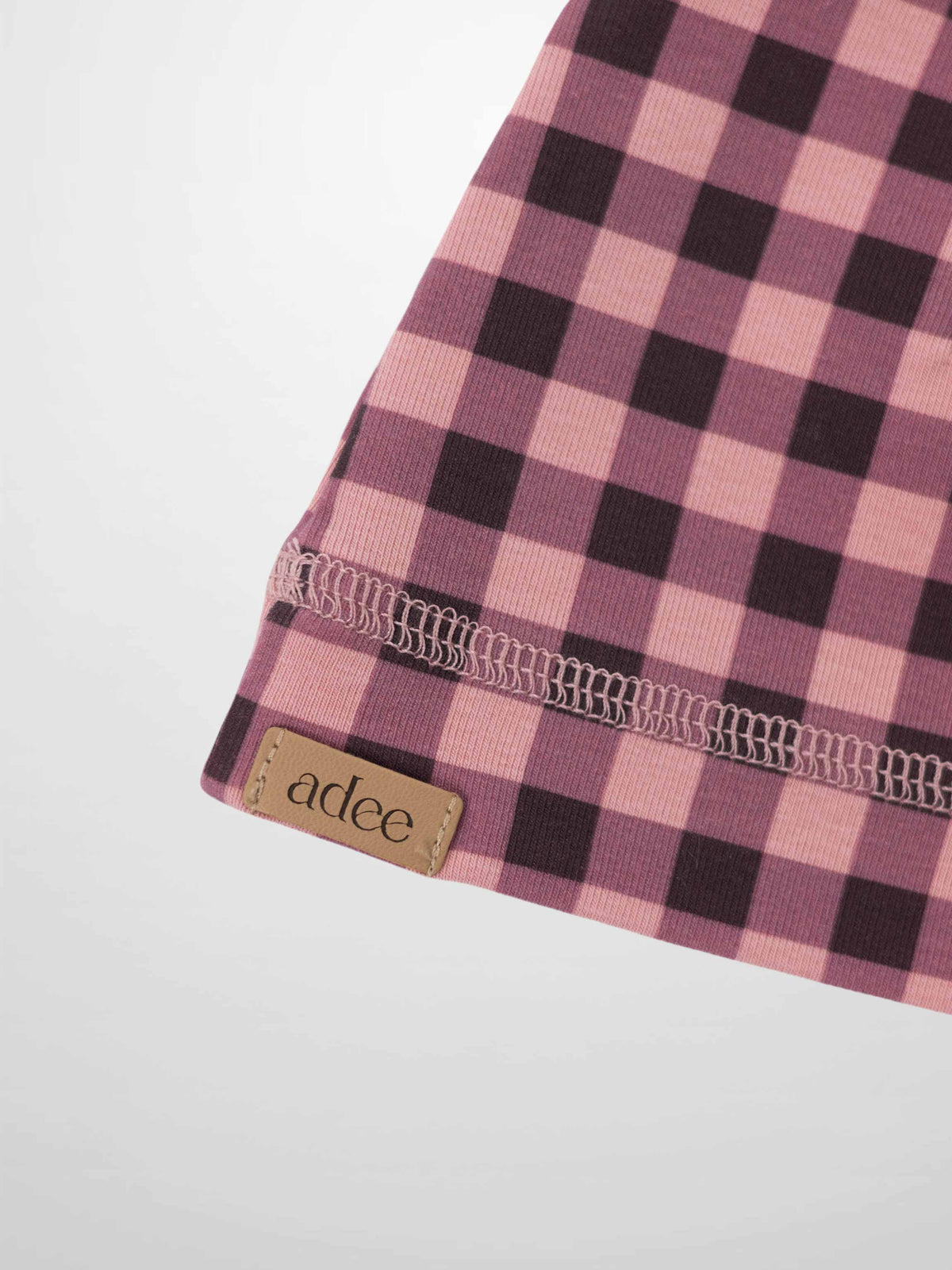 Pink gingham beanie for girls by Adee with visible brand tag.