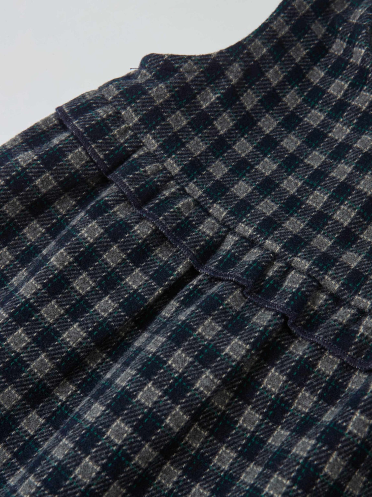 Plaid overalls with ruffles for girls in navy by Adee; dressy style, texture-rich plaid fabric detail.