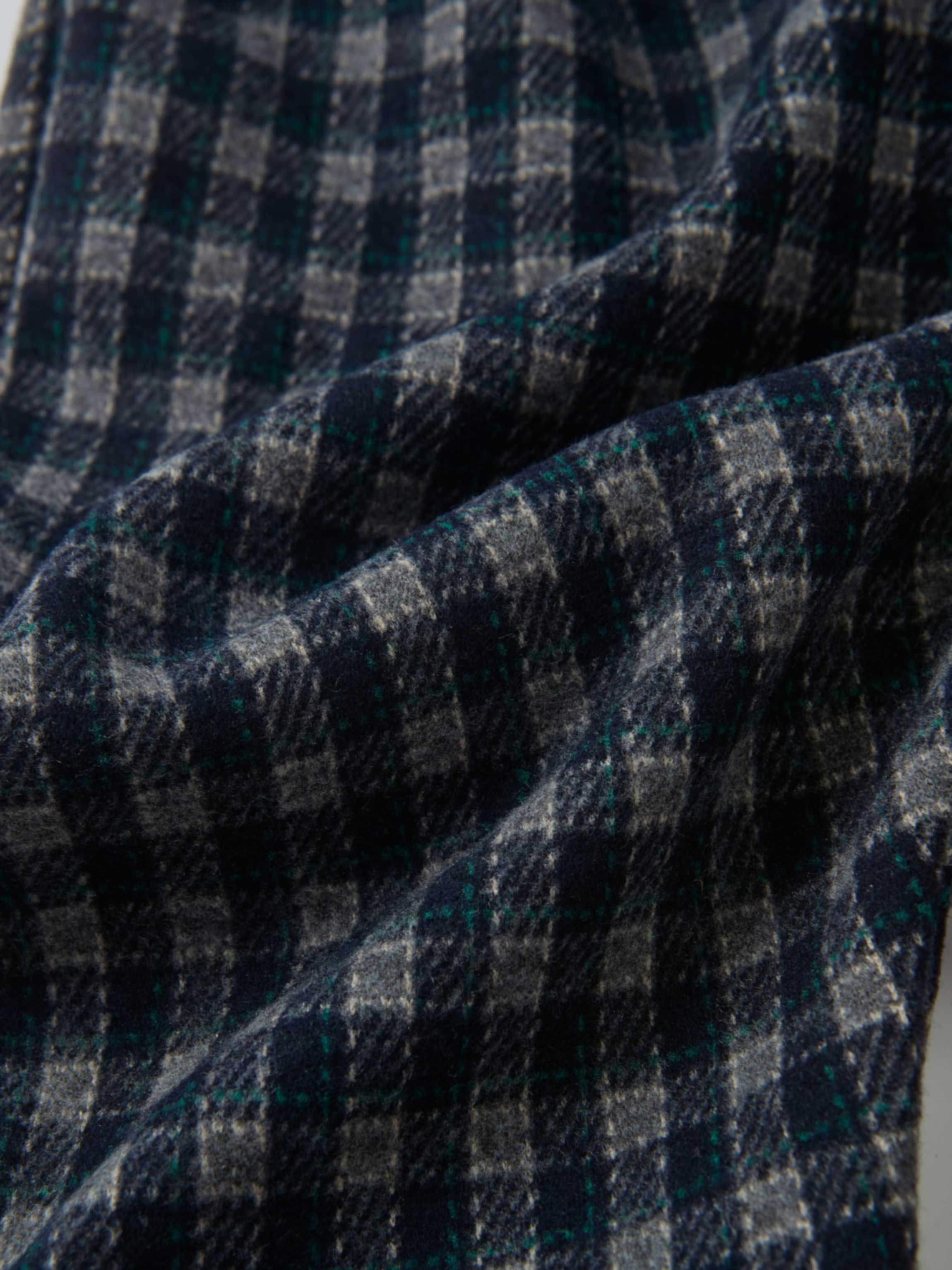 Plaid Overalls with Ruffles by Adee; navy plaid fabric close-up with gray and teal checks