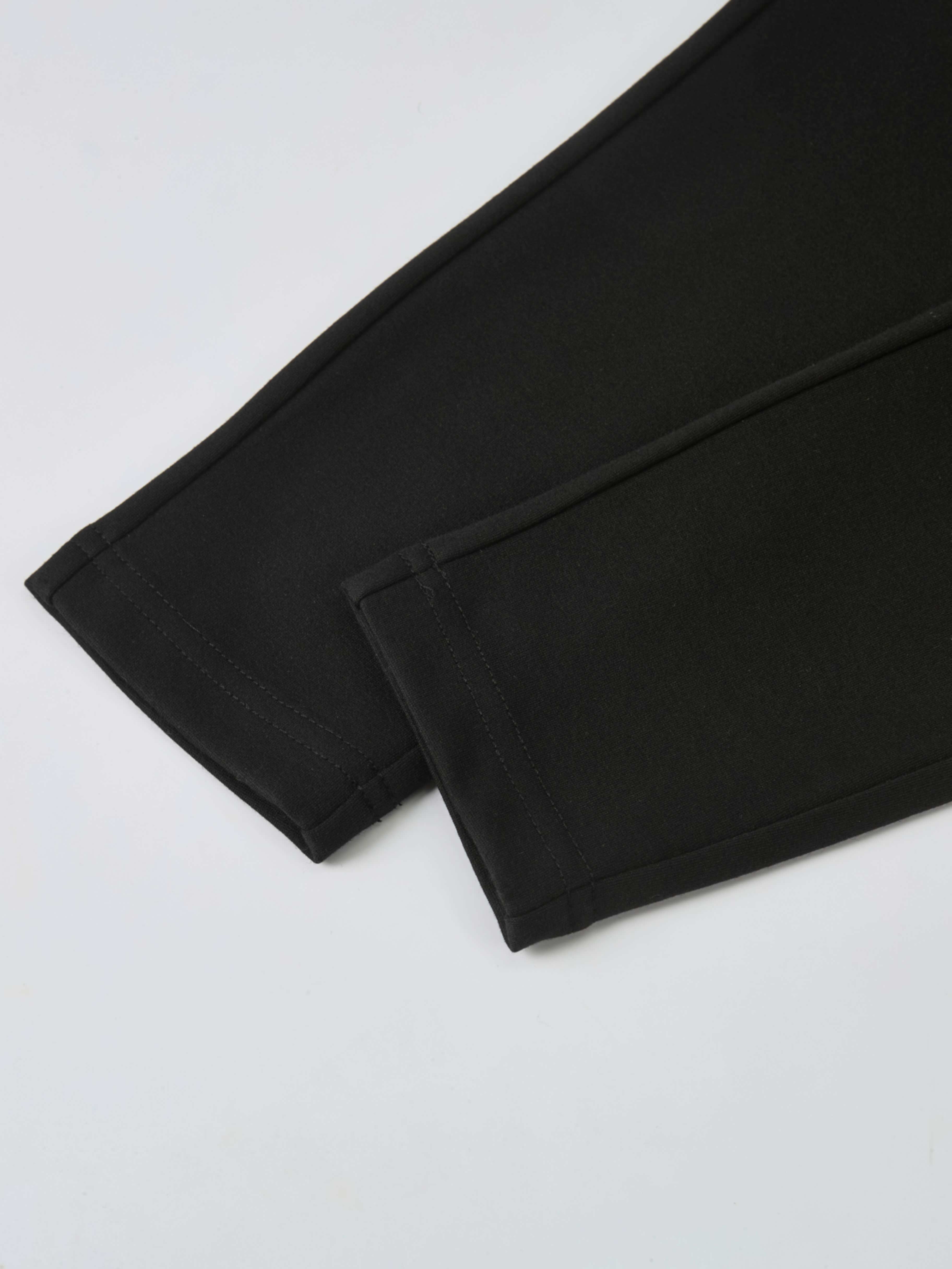 Dress pants for boys in black, dressy bottoms with neat stitched hems.