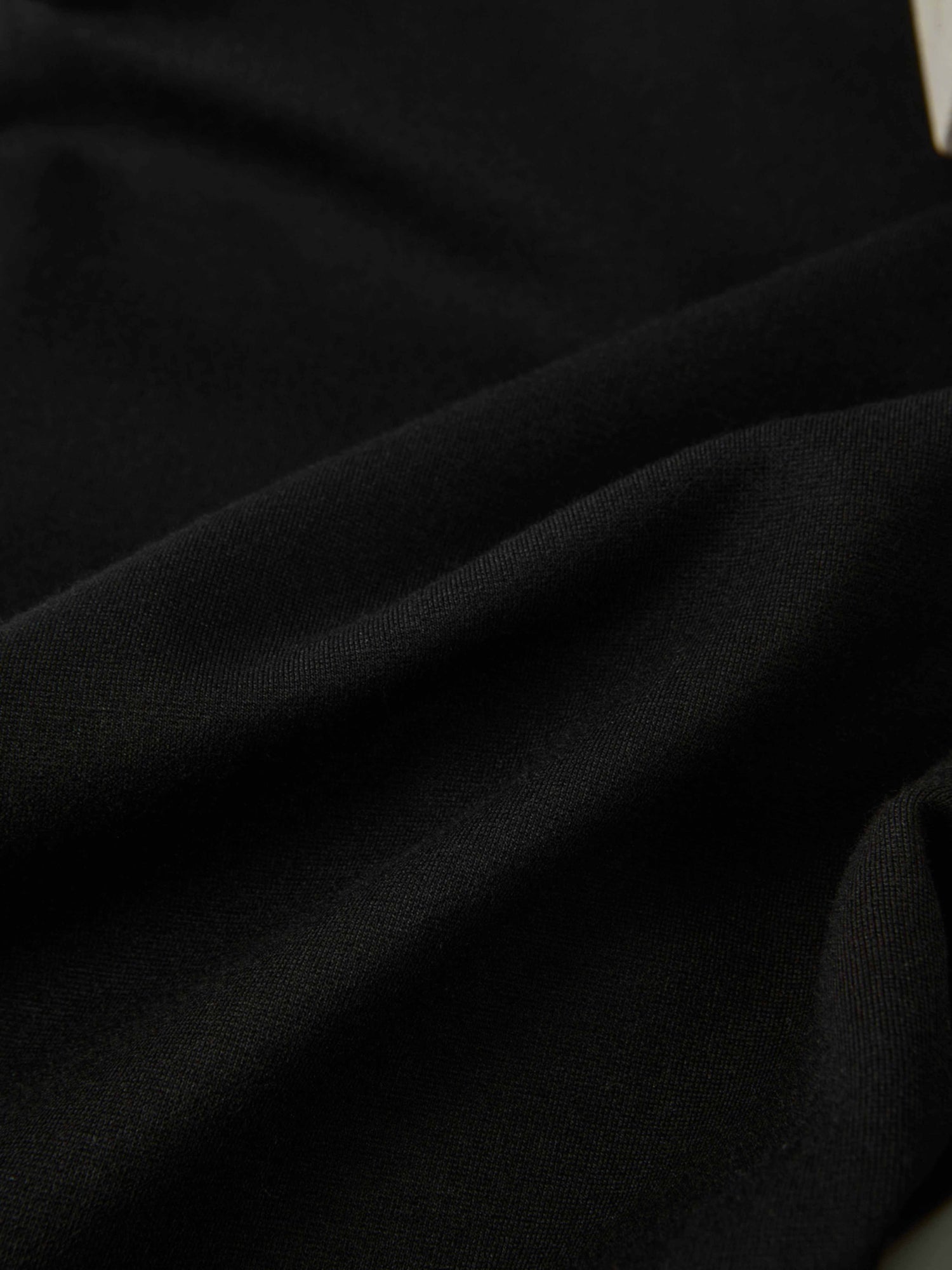 Dress pants black fabric close-up showing smooth textile texture