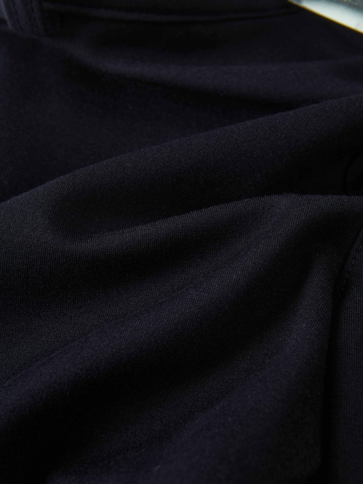 Dress pants for boys in navy fabric, close-up view of dark material