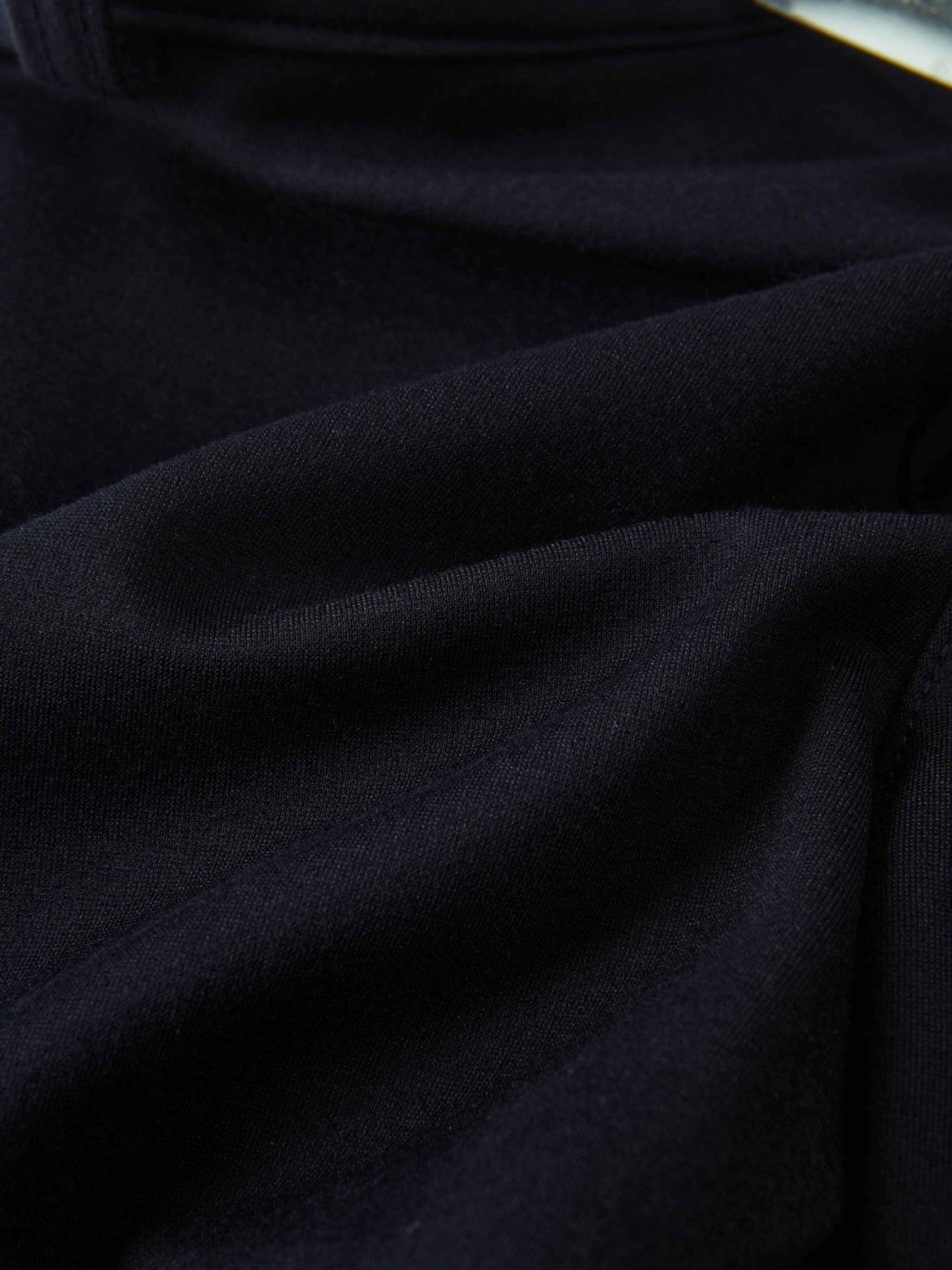 Dress pants for boys in navy fabric, close-up view of dark material