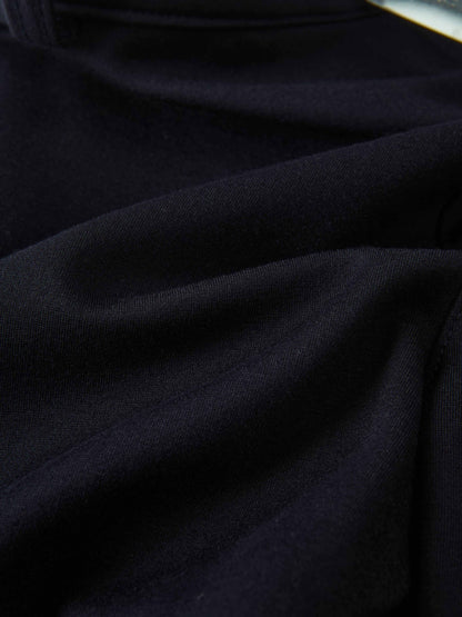 Dress pants for boys in navy fabric, close-up view of dark material
