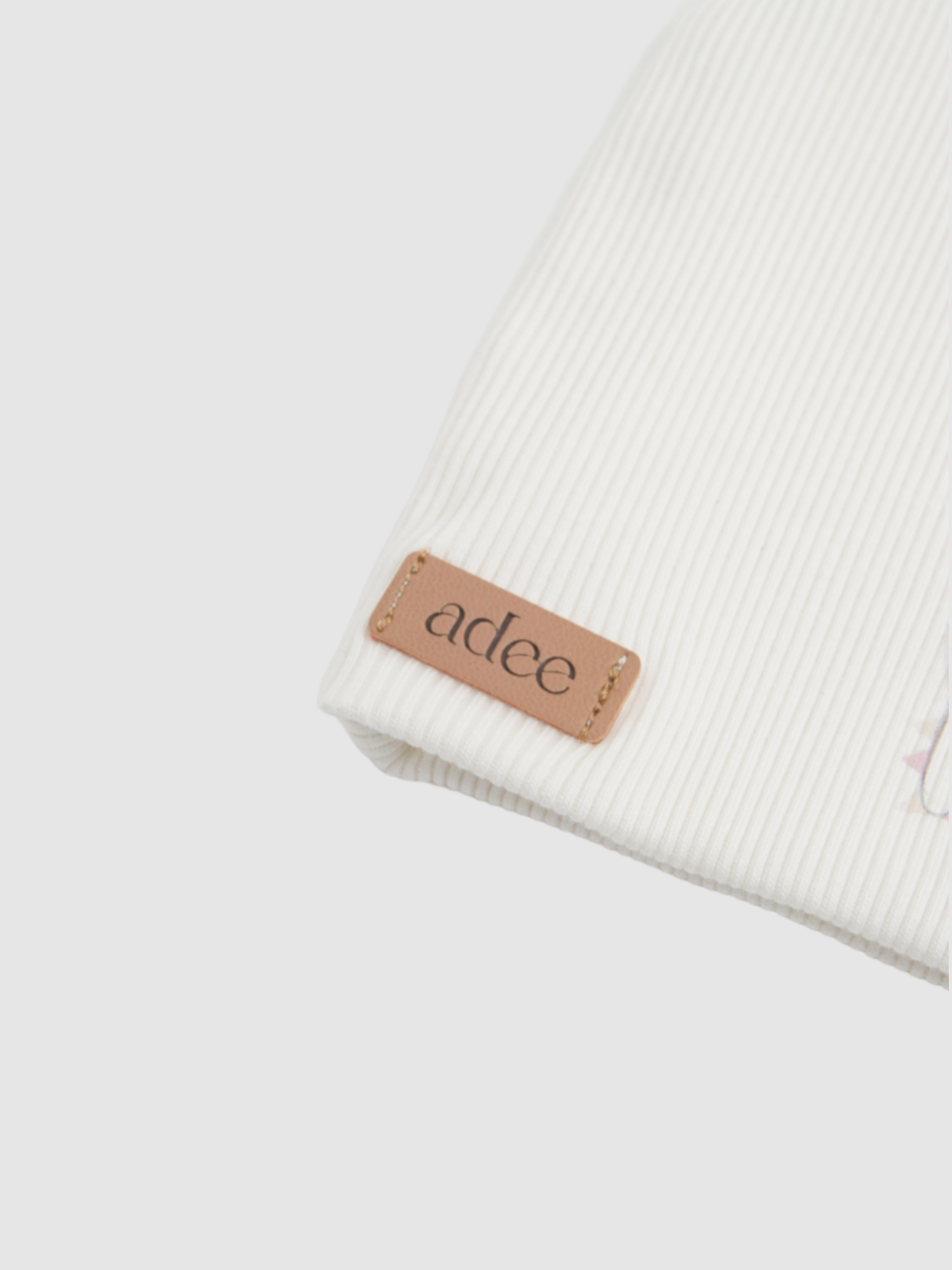 Girls beanie by Adee, white ribbed knit with tan leather logo patch