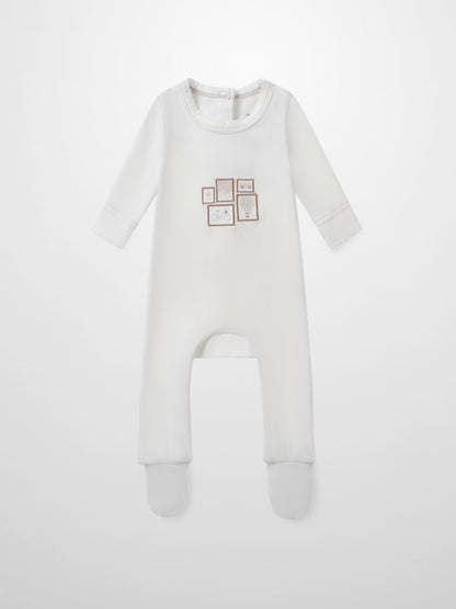 Mini Gallery Stretchy Pink girls sleeper by Adee; white footed onesie with pink framed art on chest.