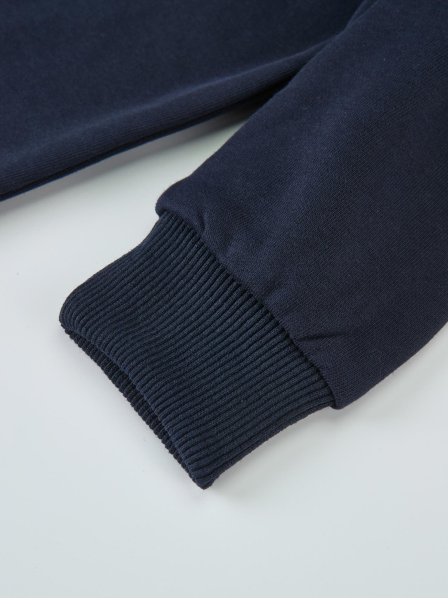 Denim Cherry Collar Dress sleeve close-up in navy fabric with ribbed cuffs