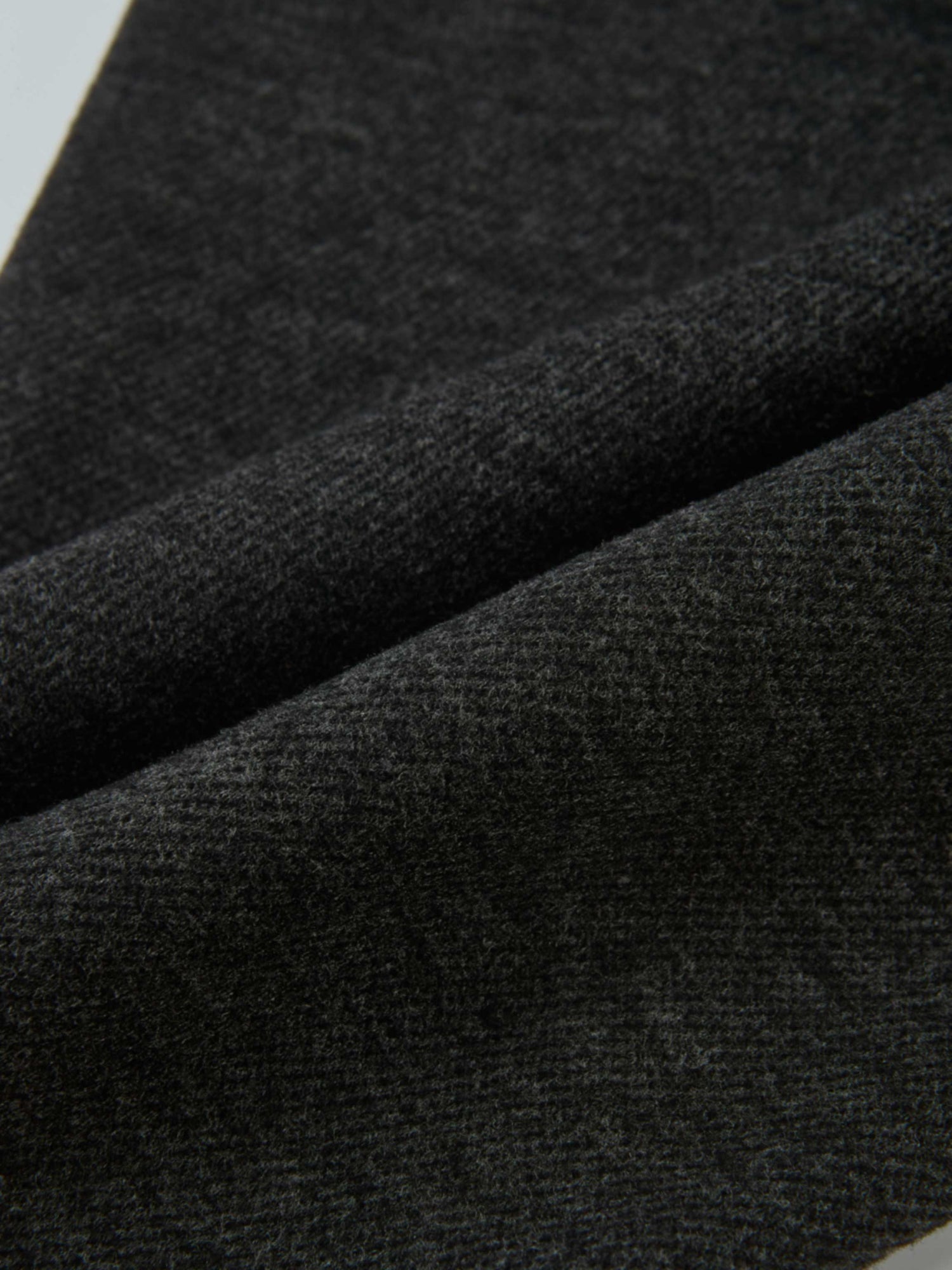 Dress pants for boys in grey; close-up of textured fabric