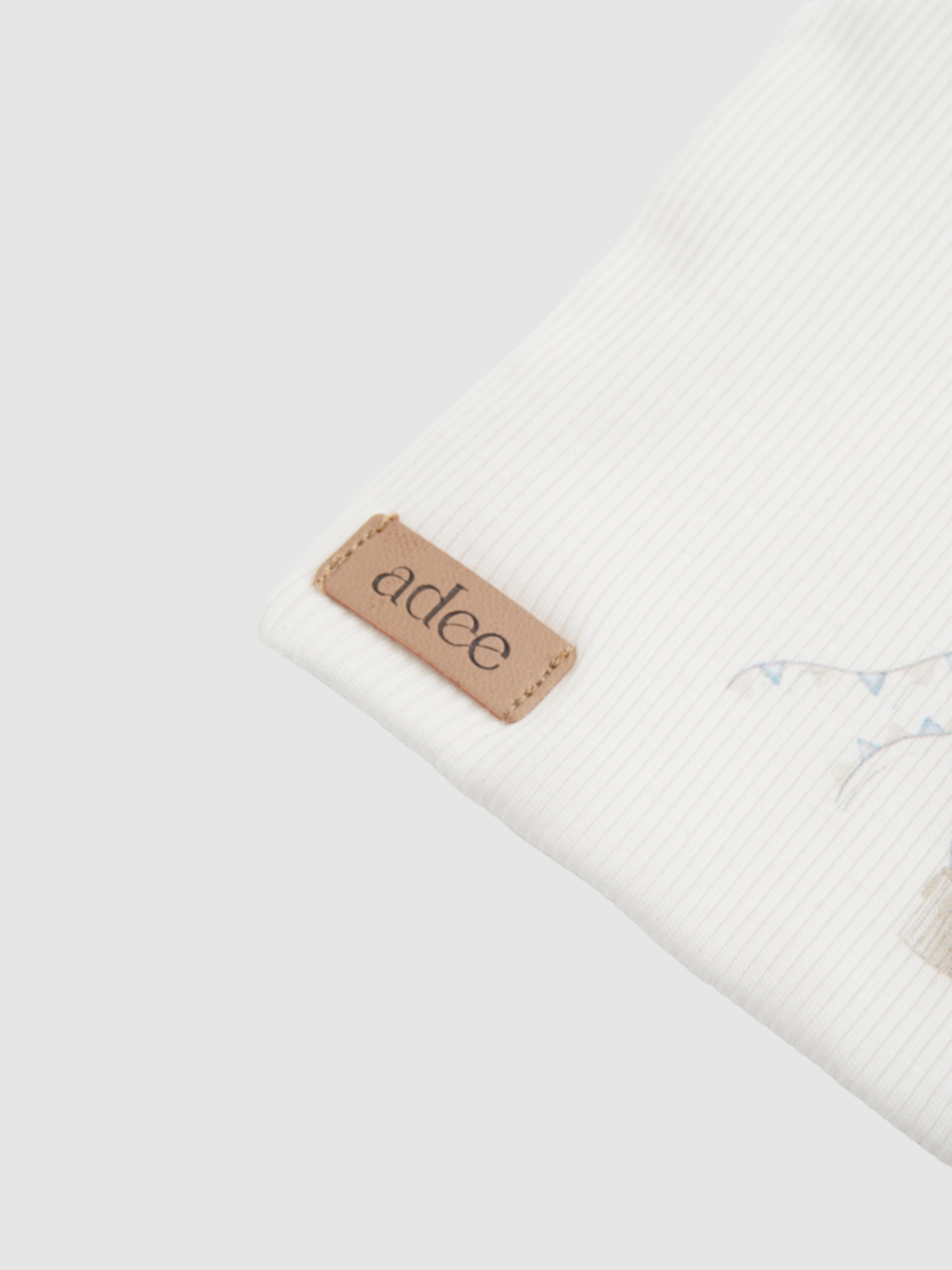 Blue Balloon Beanie for boys; white ribbed knit with blue balloon embroidery and Adee leather tag.
