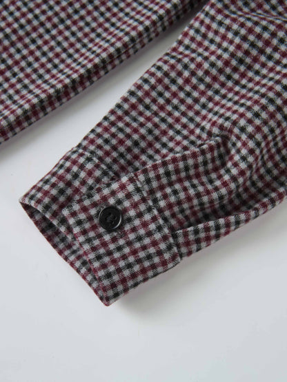 Gingham shirt for boys, grey check pattern; close-up of cuff with black button.