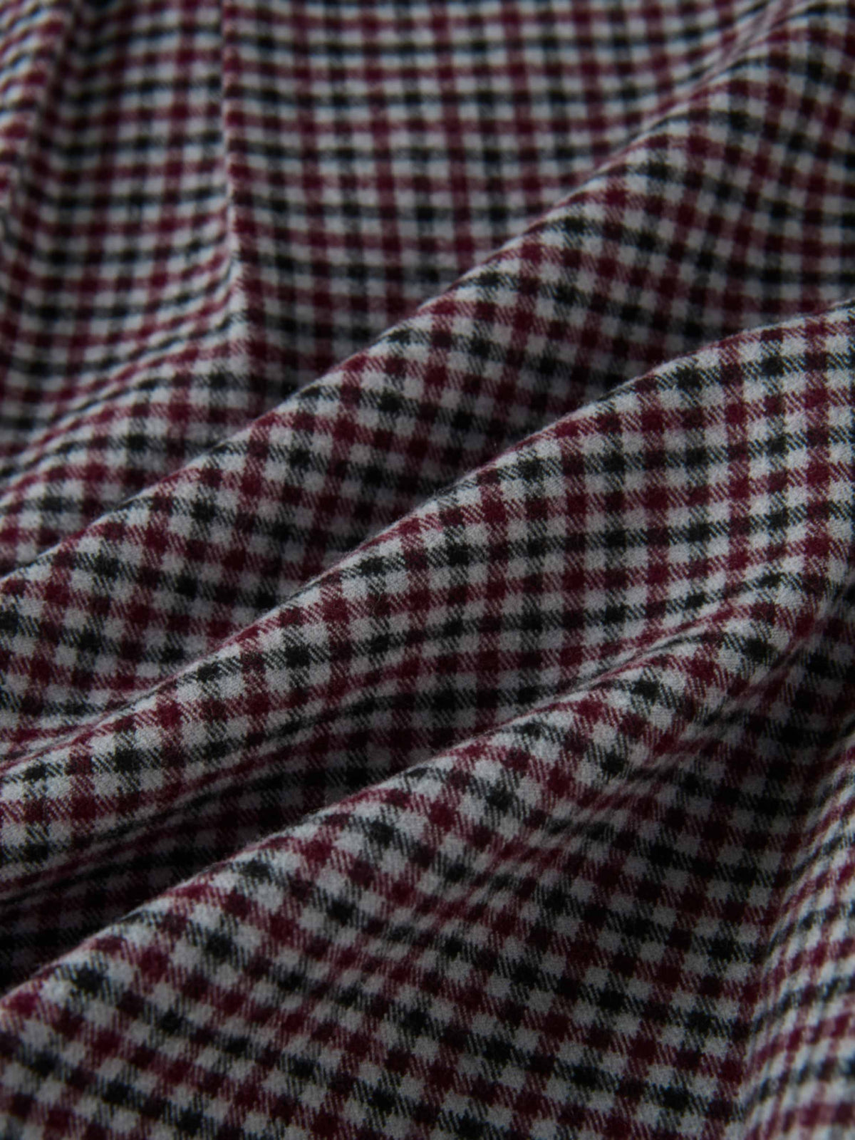 Gingham shirt fabric close-up; burgundy, black and white check pattern