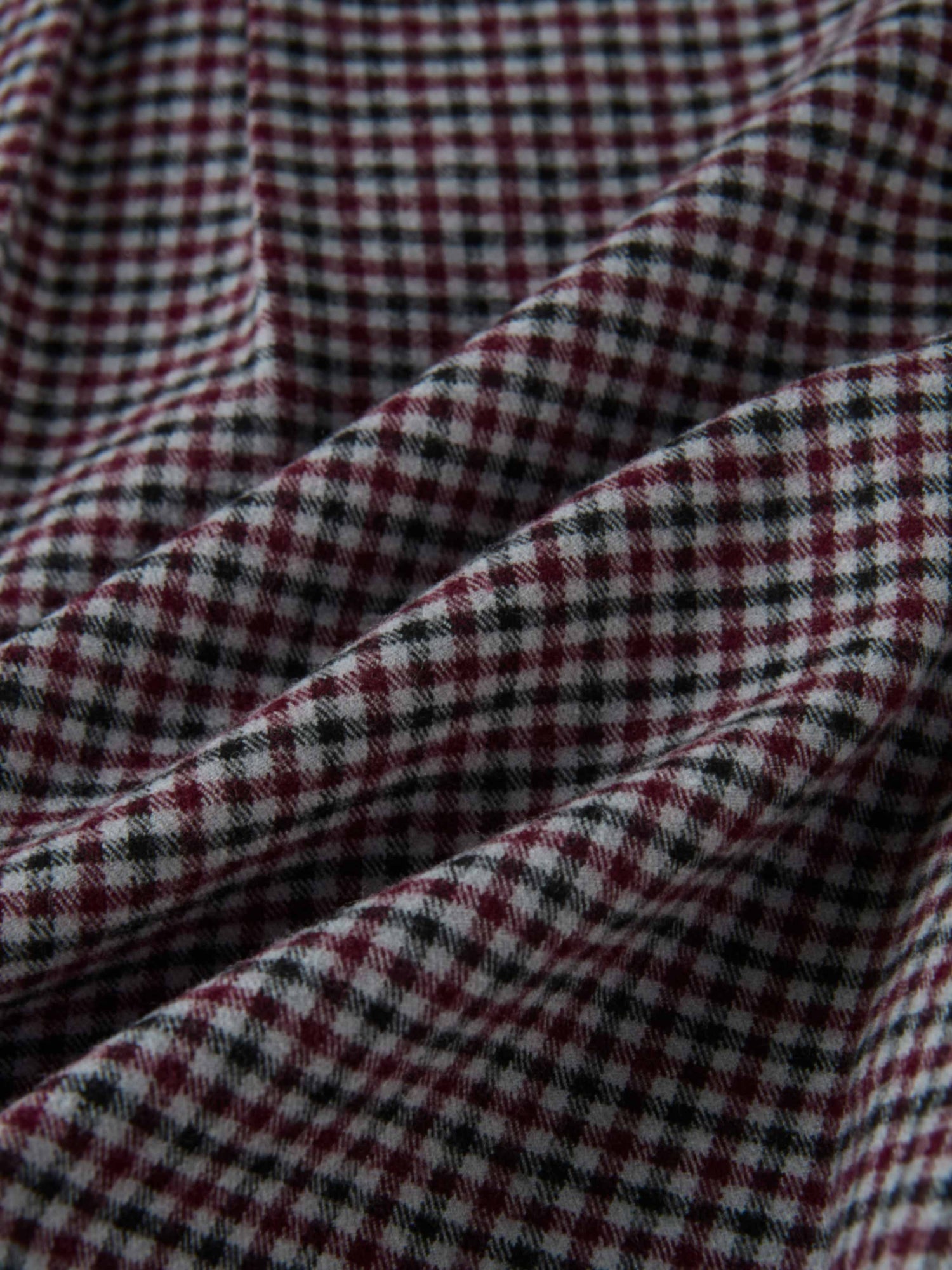 Gingham shirt fabric close-up; burgundy, black and white check pattern