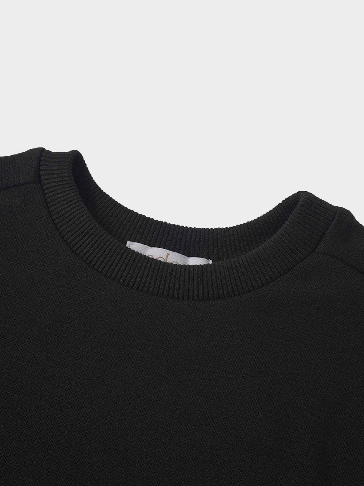 Skyline Sweatshirt close-up: black knit with ribbed crew neck.