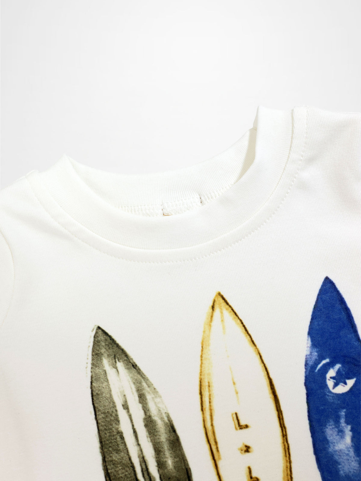 Surf Board T-shirt for boys; white cotton tee with black, yellow, and blue surfboard graphics.
