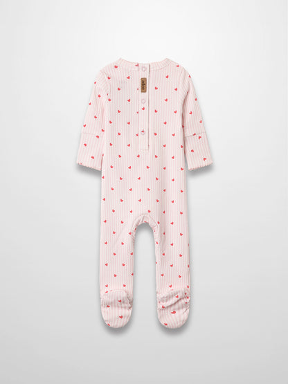 Pink striped baby jumpsuit with hot-pink hearts, scalloped trim, footed design in soft breathable fabric.