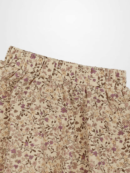 Beige floral-printed skirt with purple flowers and elastic waistband.