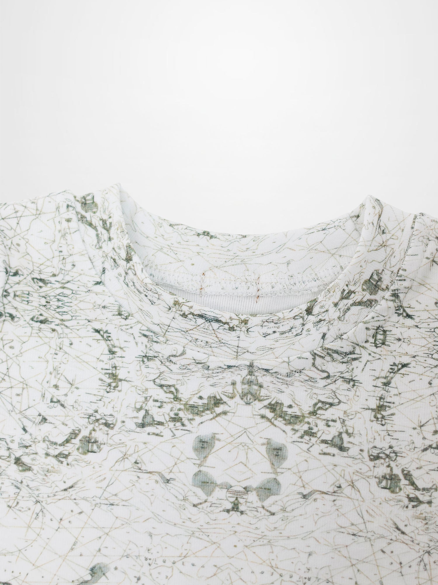 Map T-shirt with sage-green vintage map print on off-white fabric; compass markers and geographic lines.